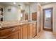 Spa-like bathroom with wood cabinets and a private door to the outside at 11105 E Tamarisk Way, Scottsdale, AZ 85262