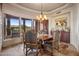 Elegant dining room with a stone floor and large windows at 11105 E Tamarisk Way, Scottsdale, AZ 85262