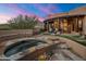 Relaxing hot tub with stone surround, nestled in a desert landscape at 11105 E Tamarisk Way, Scottsdale, AZ 85262