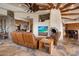 Open living room with stone fireplace and large windows at 11105 E Tamarisk Way, Scottsdale, AZ 85262