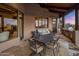 Covered patio with outdoor kitchen and seating area at 11105 E Tamarisk Way, Scottsdale, AZ 85262