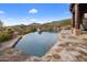 Inviting infinity pool with flagstone decking and mountain views at 11105 E Tamarisk Way, Scottsdale, AZ 85262