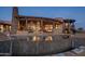 Expansive pool with a stone border reflecting the house at sunset at 11105 E Tamarisk Way, Scottsdale, AZ 85262