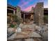 Stone steps lead to the entryway with a stone fireplace at 11105 E Tamarisk Way, Scottsdale, AZ 85262