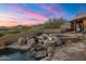 Stunning water feature with cascading waterfalls and stone accents at 11105 E Tamarisk Way, Scottsdale, AZ 85262