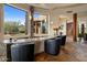 Granite wet bar with seating and stunning views at 11105 E Tamarisk Way, Scottsdale, AZ 85262