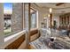 Curved granite wet bar with stone accents and large windows at 11105 E Tamarisk Way, Scottsdale, AZ 85262