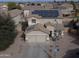 Two-story house with solar panels and a two-car garage at 11534 W Longley Ln, Youngtown, AZ 85363