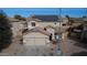 Two-story house with solar panels and a two-car garage at 11534 W Longley Ln, Youngtown, AZ 85363