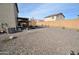 Backyard view showing gravel, covered patio and AC unit at 11534 W Longley Ln, Youngtown, AZ 85363