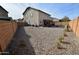 Spacious backyard with gravel and partial fence view at 11534 W Longley Ln, Youngtown, AZ 85363