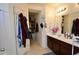 Bathroom with double vanity, linen closet, and shower/tub combo at 11534 W Longley Ln, Youngtown, AZ 85363