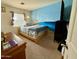 Bedroom with beach mural, comfortable bed, and ample closet space at 11534 W Longley Ln, Youngtown, AZ 85363