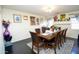 Formal dining room with dark wood table and six chairs at 11534 W Longley Ln, Youngtown, AZ 85363