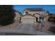 Two-story house with solar panels and a two-car garage at 11534 W Longley Ln, Youngtown, AZ 85363