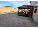 Covered patio with seating area in the backyard at 11534 W Longley Ln, Youngtown, AZ 85363