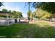 Community playground with play structure and covered seating at 11534 W Longley Ln, Youngtown, AZ 85363