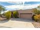 Tan stucco house with a two-car garage and desert landscaping at 11686 N Spotted Horse Way, Fountain Hills, AZ 85268