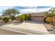 Tan stucco house with a two-car garage and mature desert landscaping at 11686 N Spotted Horse Way, Fountain Hills, AZ 85268