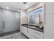 Contemporary bathroom with gray tile shower and floating vanity at 12201 N 65Th St, Scottsdale, AZ 85254