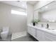 Modern bathroom with white vanity and gray tile floor at 12201 N 65Th St, Scottsdale, AZ 85254