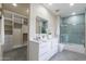 Modern bathroom with white vanity and blue tile shower at 12201 N 65Th St, Scottsdale, AZ 85254