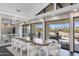 Modern dining room with a large wooden table and white chairs at 12201 N 65Th St, Scottsdale, AZ 85254