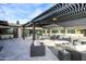 Relaxing patio area featuring a pergola and comfortable seating at 12201 N 65Th St, Scottsdale, AZ 85254