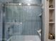 Modern shower with blue tile and glass enclosure at 12201 N 65Th St, Scottsdale, AZ 85254