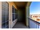 Private balcony with door access and views of neighboring buildings at 14575 W Mountain View Blvd # 12303, Surprise, AZ 85374