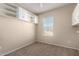 Bedroom with window, ceiling fan and built-in shelving at 14575 W Mountain View Blvd # 12303, Surprise, AZ 85374