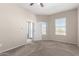 Bright bedroom with carpet flooring and access to a balcony at 14575 W Mountain View Blvd # 12303, Surprise, AZ 85374