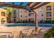 Inviting pool area with lounge chairs and pergola for shade at 14575 W Mountain View Blvd # 12303, Surprise, AZ 85374