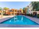 Community swimming pool with plenty of lounge chairs for relaxation at 14575 W Mountain View Blvd # 12303, Surprise, AZ 85374