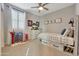 Bright bedroom with window shutters, dresser, and bed at 15207 S 183Rd Ave, Goodyear, AZ 85338