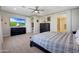 Bright bedroom with a comfortable bed and large TV at 15207 S 183Rd Ave, Goodyear, AZ 85338