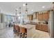 Bright kitchen with an island, dining area, and view from window at 15207 S 183Rd Ave, Goodyear, AZ 85338