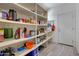 Well-stocked pantry with ample shelving for storage at 15207 S 183Rd Ave, Goodyear, AZ 85338