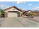 Single-story home with attached two-car garage and desert landscaping at 15820 W Falcon Ridge Dr, Sun City West, AZ 85375