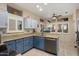 Modern kitchen with blue cabinets, granite countertops, and stainless steel appliances at 15820 W Falcon Ridge Dr, Sun City West, AZ 85375