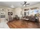 Living room with hardwood floors, two recliners and a sofa at 15820 W Falcon Ridge Dr, Sun City West, AZ 85375