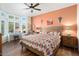 Comfortable main bedroom with an orange accent wall and wood flooring at 15820 W Falcon Ridge Dr, Sun City West, AZ 85375