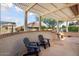 Relaxing covered patio with flagstone flooring and seating area at 15820 W Falcon Ridge Dr, Sun City West, AZ 85375