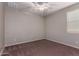 Well-lit bedroom featuring a ceiling fan and carpet at 16019 W Avenida Del Sol --, Surprise, AZ 85387