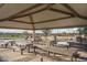 Community picnic area with covered tables and benches at 16019 W Avenida Del Sol --, Surprise, AZ 85387