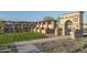 Community entrance with stone arch and landscaping at 16019 W Avenida Del Sol --, Surprise, AZ 85387