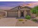 One-story home with brown garage door and stone accents at 16019 W Avenida Del Sol --, Surprise, AZ 85387