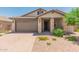 One-story house with brown garage door and stone accents at 16019 W Avenida Del Sol --, Surprise, AZ 85387