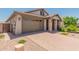 One story home with brown garage door and stone pillars at 16019 W Avenida Del Sol --, Surprise, AZ 85387