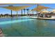 Community pool with shade structures and palm trees at 16019 W Avenida Del Sol --, Surprise, AZ 85387